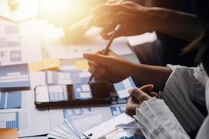 Close up ux developer and ui designer brainstorming about mobile app interface wireframe design on table with customer breif and color code at modern office.Creative digital development agency photo
