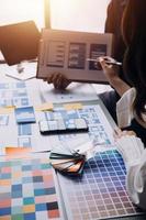 Close up ux developer and ui designer brainstorming about mobile app interface wireframe design on table with customer breif and color code at modern office.Creative digital development agency photo