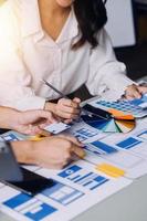 Close up ux developer and ui designer brainstorming about mobile app interface wireframe design on table with customer breif and color code at modern office.Creative digital development agency photo