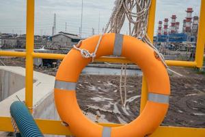 Safety flotation ring on water storage and water treatment area, for emergency action. The photo is suitable to use for safety background photography, power plant poster and electricity content media.