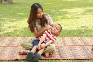 Mother and baby playing in the park happily. photo