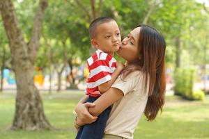 Mother and baby playing in the park happily. photo