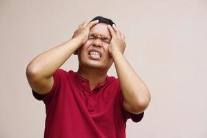 Asian man has a headache stress from work photo