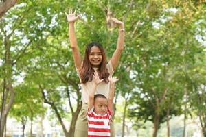 Mother and baby playing in the park happily. photo