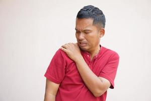 Man suffering from shoulder pain from work photo