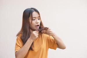 Asian women have damaged hair, dandruff and split ends. photo