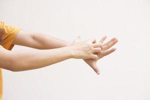 Asian woman having itchy skin on hands photo