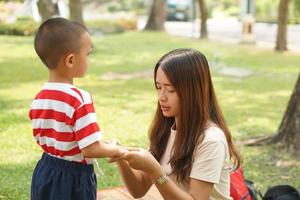 Mother and baby playing in the park happily. photo