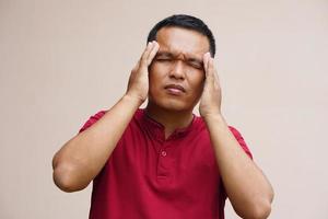 Asian man has a headache stress from work photo