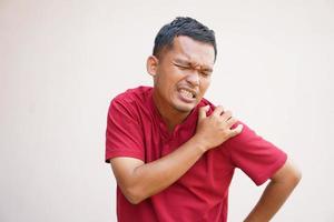 Man suffering from shoulder pain from work photo