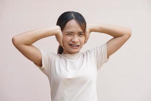 Asian woman covering her ears with her hands photo