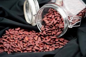 dried red kidney beans on olive wood photo