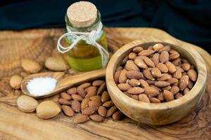 roasted and salted almonds on olive wood photo