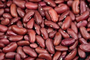 dried red kidney beans on olive wood photo
