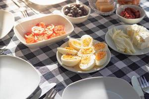 Breakfast with egg, olive, cheese, plate with cutlery photo