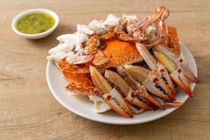 Steamed blue crab with spicy seafood sauce photo