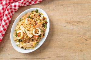 Instant noodle spicy salad with mixed meats photo