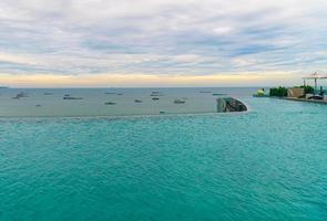 swimming pool with ocean sea and boat background photo