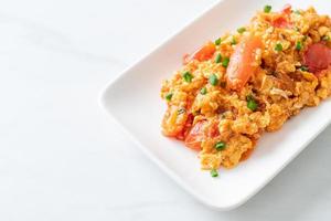 Stir-fried tomatoes with egg or Scrambled eggs with tomatoes photo