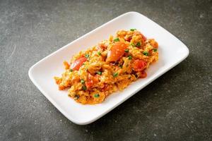 Stir-fried tomatoes with egg or Scrambled eggs with tomatoes photo