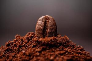 Closeup of coffee beans at the mixed heap of roasted coffee with copy space for text. Concept of Coffee freshness photo