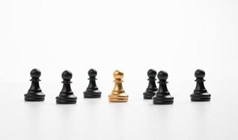 Golden chess pawn standing with the team to show influence and empowerment. Concept of business leadership for leader team, successful competition winner and Leader with influence photo