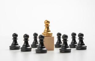 The leadership of the Golden Chess pawn standing on the box show influence and empowerment. Concept of business leadership for leader team, successful competition winner and Leader with strategy photo