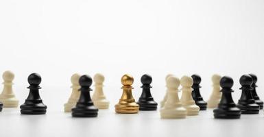 Golden Chess pawn standing to Be around of other chess, Concept of a leader must have courage and challenge in the competition, leadership and business vision for a win in business games photo