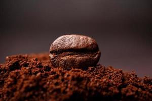 Closeup of coffee beans at the mixed heap of roasted coffee with copy space for text. Concept of Coffee freshness photo