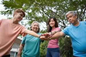 Healthy family group instructors workout in fresh air, and they rest and stand together after morning exercises in park. Outdoor activities, healthy lifestyle, strong bodies, fit figures, health care. photo