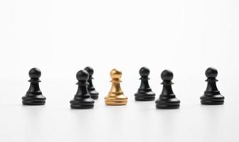 Golden chess pawn standing with the team to show influence and empowerment. Concept of business leadership for leader team, successful competition winner and Leader with influence photo