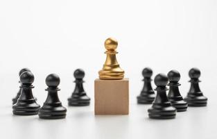 The leadership of the Golden Chess pawn standing on the box show influence and empowerment. Concept of business leadership for leader team, successful competition winner and Leader with strategy photo