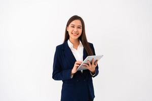 Portrait of happy young thoughtful Asian women think for new ideas and holding tablet on isolated white background. Concept of advertising marketing and product placement. photo