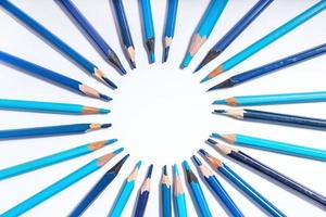 blue pencils lined up in a circle on a white background. photo with round frame for copy space