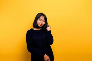 Cute Asian girl smiling on yellow background. Empty, young woman. Place for advertisement. copy space photo