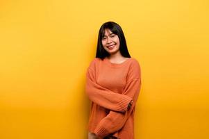 Cute Asian girl smiling on yellow background. Empty, young woman. Place for advertisement. copy space photo