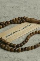 Islamic quotes. Ramadhan Kareem text on wooden stick. photo