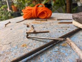 a close up of some iron nails on a blue table photo