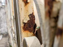 a close up of rusty white iron railings photo