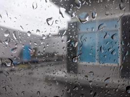 a raindrops dripping down the windshield of the car. For raindrops background. No people photo