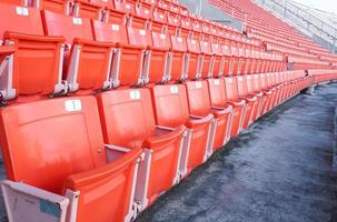 Empty orange seats at stadium,Rows of seat on a soccer stadium photo