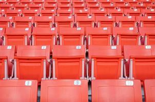 Empty orange seats at stadium,Rows of seat on a soccer stadium photo