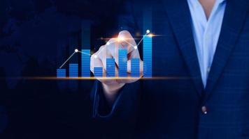 Businessman finger touch symbol stock graph and chart background, concept growth and development business investment, Stock market and strategy making market plan and stock market fluctuations photo