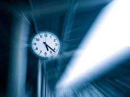 Clock with motion background ,conceptual image of time running or passing away effect zoom out alarm clock to movements photo