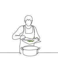 men in an apron pours chopped greens into a pan with a cutting board with a knife - one line drawing vector. cooking concept vector