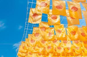 Thammachak flag yellow in temple Wat Phan tao on blue sky temple Northern Thailand photo