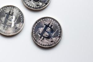 Top view of silver bitcoins on white color background photo