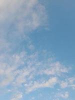 Beautiful white clouds on deep blue sky background. Large bright soft fluffy clouds are cover the entire blue sky. photo