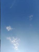 Beautiful white clouds on deep blue sky background. Large bright soft fluffy clouds are cover the entire blue sky. photo