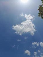 Beautiful white clouds on deep blue sky background. Large bright soft fluffy clouds are cover the entire blue sky. photo